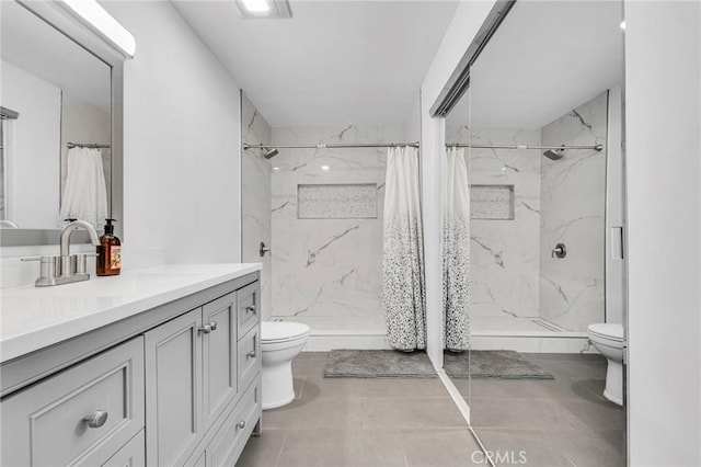 full bath featuring toilet, a marble finish shower, and vanity