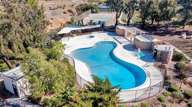 pool with fence and a patio