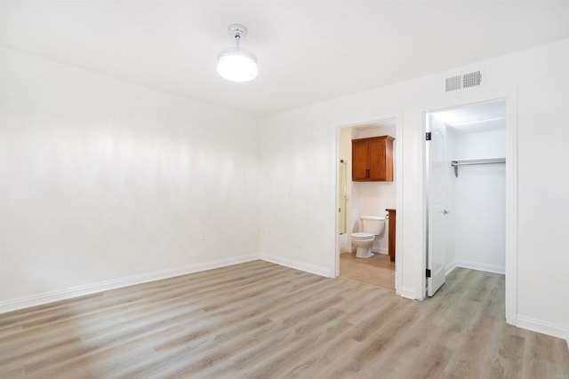 800 Sea Cliff Way Unit 801, Oceanside, CA 92056 - unfurnished bedroom featuring light wood-style flooring, a walk in closet, a closet, and ensuite bath
