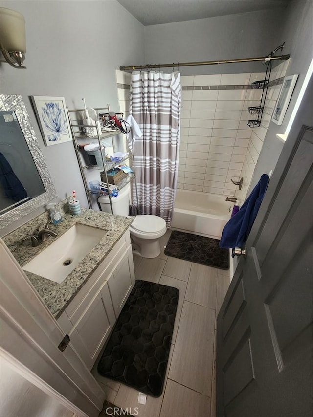 bathroom with shower / tub combo, vanity, and toilet