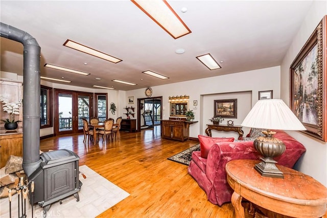 293 Fairway Dr, Lake Arrowhead, CA 92352 - living room with french doors, light wood-style floors, and a wood stove