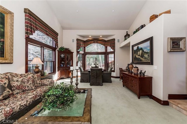 293 Fairway Dr, Lake Arrowhead, CA 92352 - living area featuring high vaulted ceiling, baseboards, a healthy amount of sunlight, and light colored carpet
