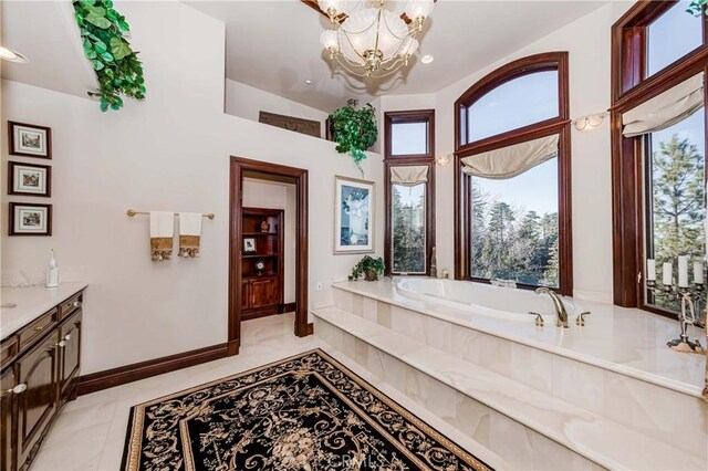 293 Fairway Dr, Lake Arrowhead, CA 92352 - full bathroom with tile patterned floors, vanity, a garden tub, a chandelier, and baseboards