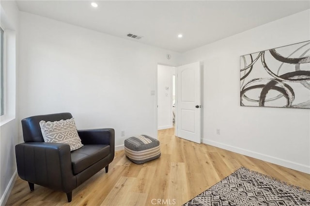 sitting room featuring recessed lighting, wood finished floors, visible vents, and baseboards