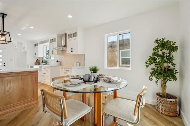 dining area featuring recessed lighting and light wood finished floors