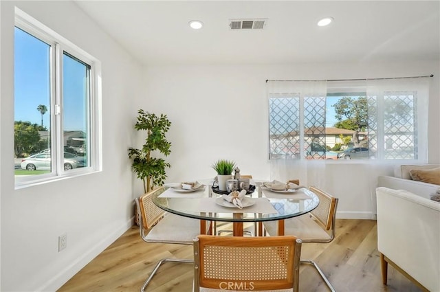 dining area featuring a wealth of natural light, visible vents, recessed lighting, and wood finished floors