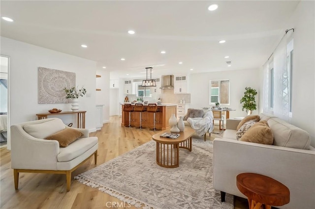 living room with light wood-style floors and recessed lighting