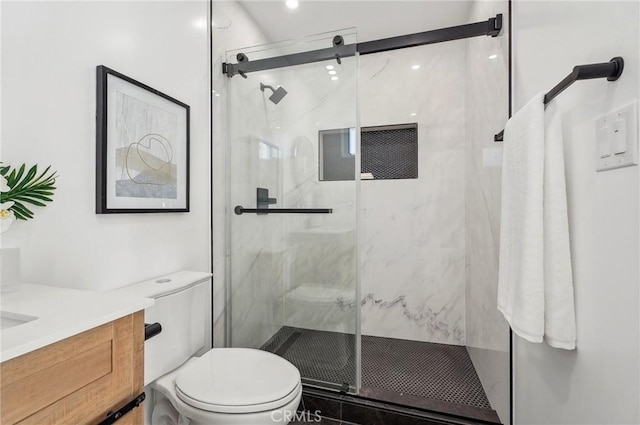 full bath featuring a marble finish shower, vanity, and toilet