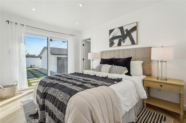 bedroom featuring access to outside, wood finished floors, and recessed lighting