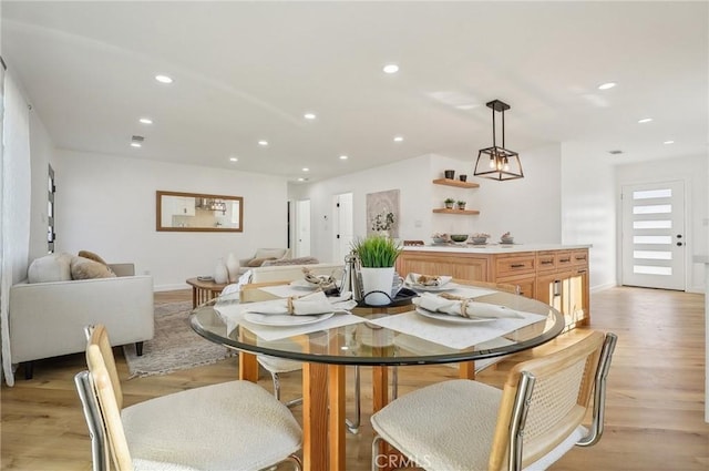 dining room featuring baseboards, light wood-type flooring, and recessed lighting