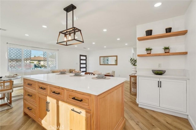 kitchen with light countertops, light wood-type flooring, open shelves, and recessed lighting