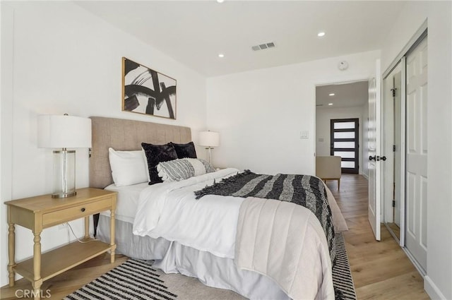 bedroom featuring recessed lighting, visible vents, and light wood finished floors