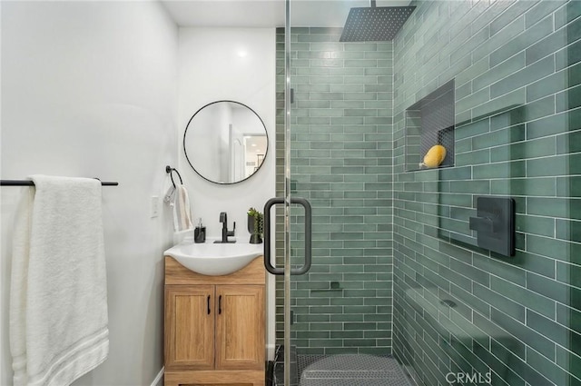 bathroom with a shower stall and vanity