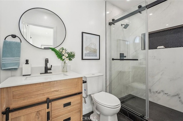 full bath featuring vanity, a marble finish shower, and toilet