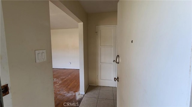 hall with light tile patterned floors