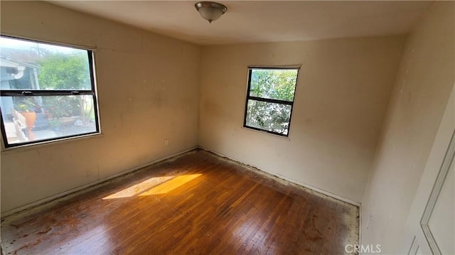 unfurnished room with wood finished floors