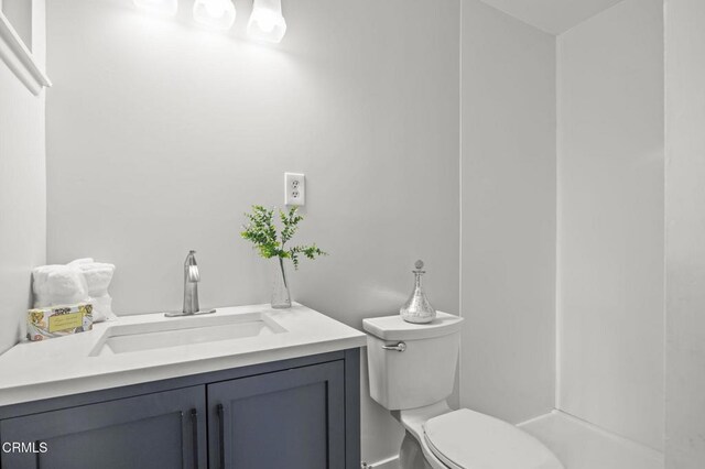 bathroom featuring toilet and vanity