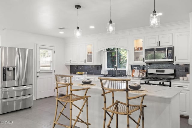 kitchen with white cabinets, visible vents, appliances with stainless steel finishes, and a sink