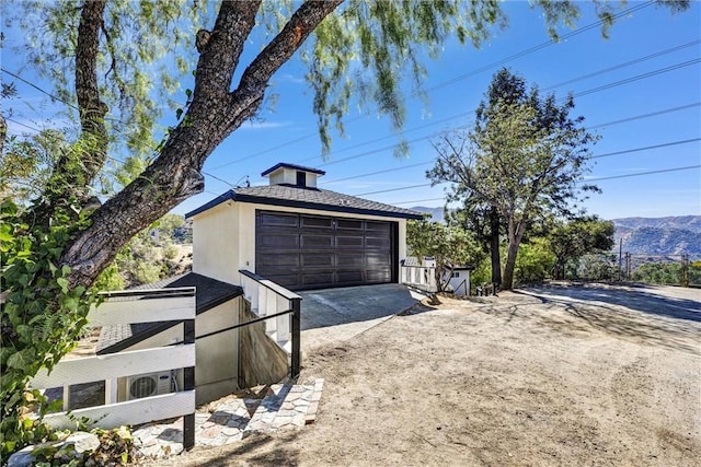 detached garage featuring a mountain view