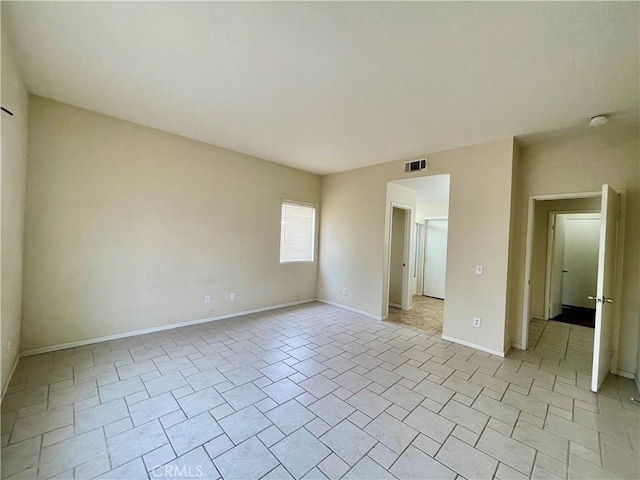 unfurnished bedroom featuring baseboards and visible vents