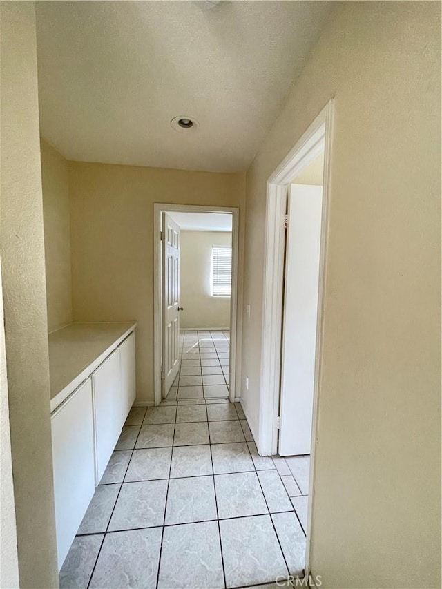 hallway featuring light tile patterned flooring