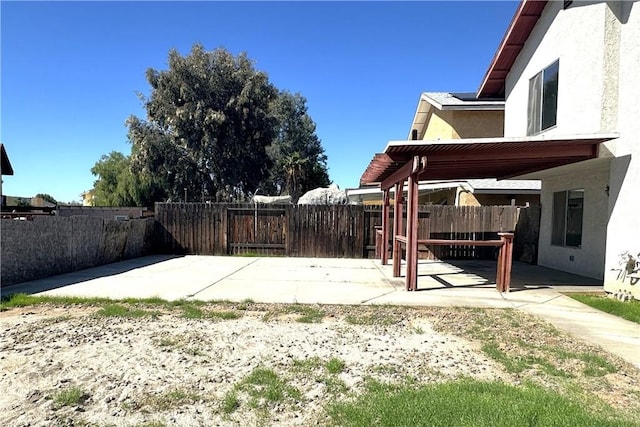 view of yard with a patio area, a fenced backyard, and a pergola