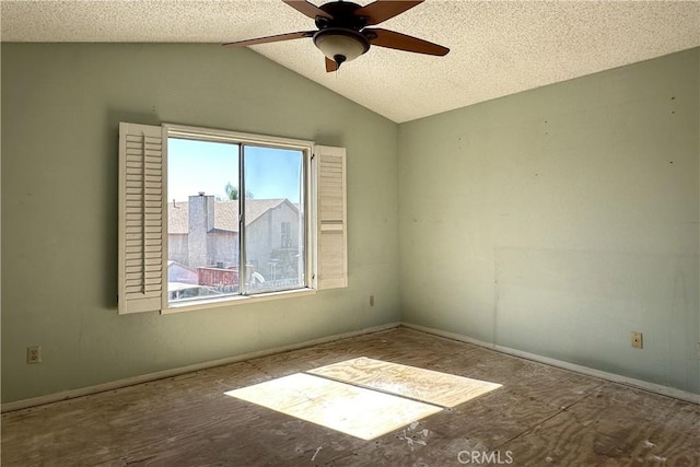 spare room with a ceiling fan, lofted ceiling, and a textured ceiling