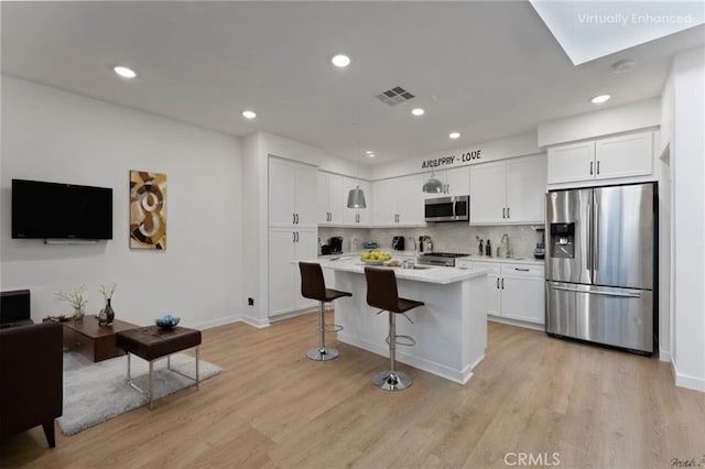 kitchen with visible vents, white cabinets, appliances with stainless steel finishes, and light countertops