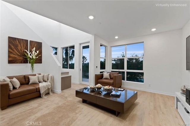 living area featuring recessed lighting, baseboards, and light wood finished floors