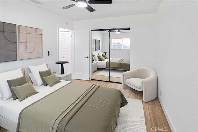 bedroom with baseboards, a closet, a ceiling fan, and wood finished floors