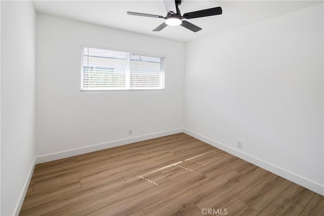 spare room with ceiling fan, baseboards, and wood finished floors