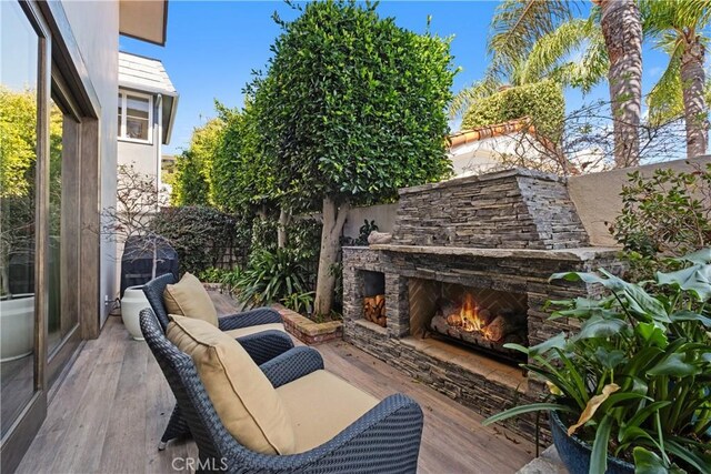 504 Evening Star Ln, Newport Beach, CA 92660 - view of patio with fence and an outdoor stone fireplace