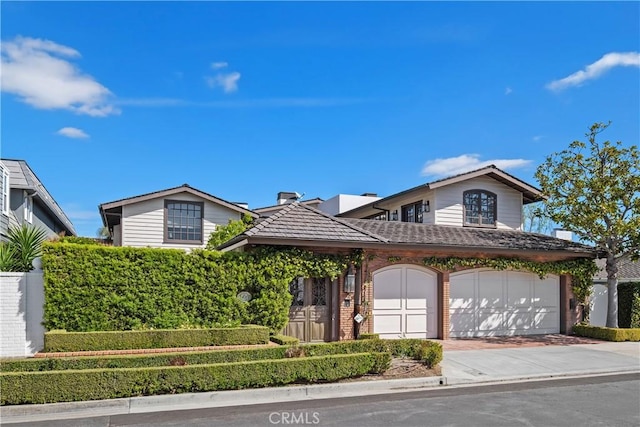 504 Evening Star Ln, Newport Beach, CA 92660 - view of front of home featuring a garage, brick siding, and decorative driveway