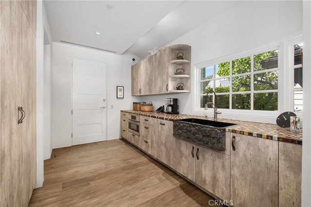 504 Evening Star Ln, Newport Beach, CA 92660 - kitchen featuring tile counters, oven, light wood-style floors, open shelves, and a sink