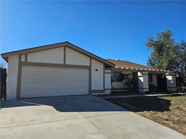 view of front facade with concrete driveway and an attached garage