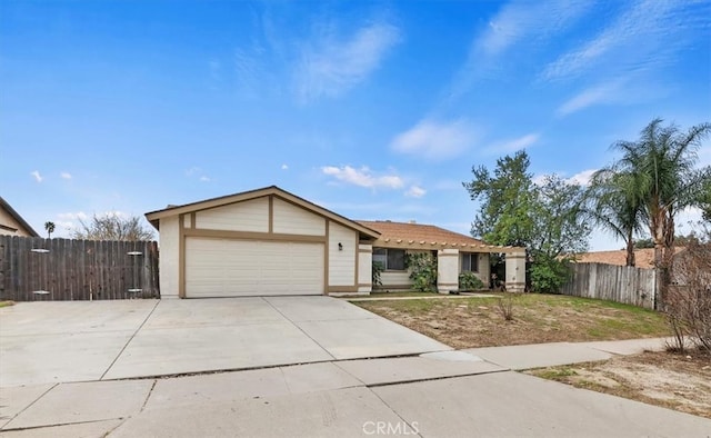 ranch-style home featuring driveway, an attached garage, and fence