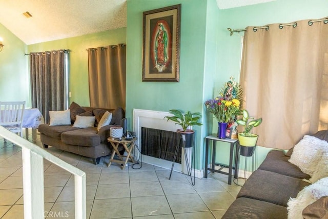 tiled living area featuring lofted ceiling and a fireplace