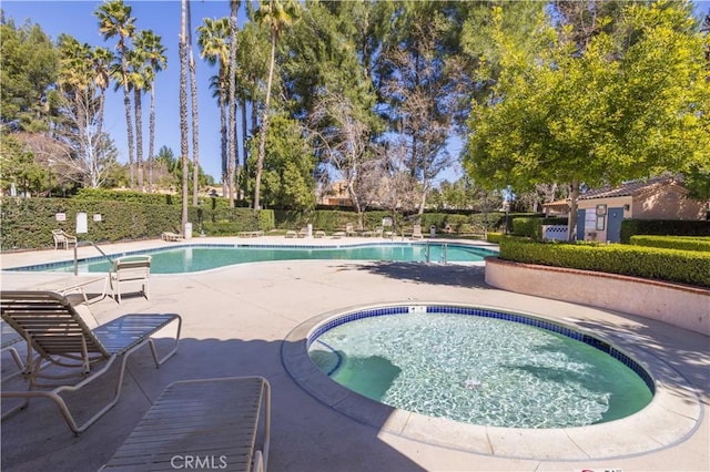 25214 Steinbeck Ave Unit G, Stevenson Ranch, CA 91381 - pool featuring fence, a community hot tub, and a patio