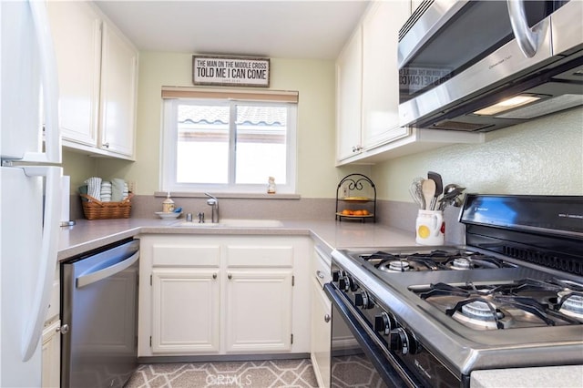 25214 Steinbeck Ave Unit G, Stevenson Ranch, CA 91381 - kitchen featuring white cabinetry, appliances with stainless steel finishes, light countertops, and a sink