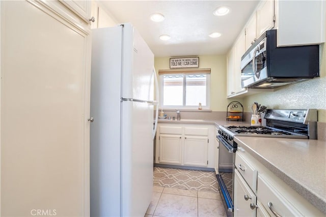 kitchen featuring stainless steel appliances, recessed lighting, white cabinets, and light countertops