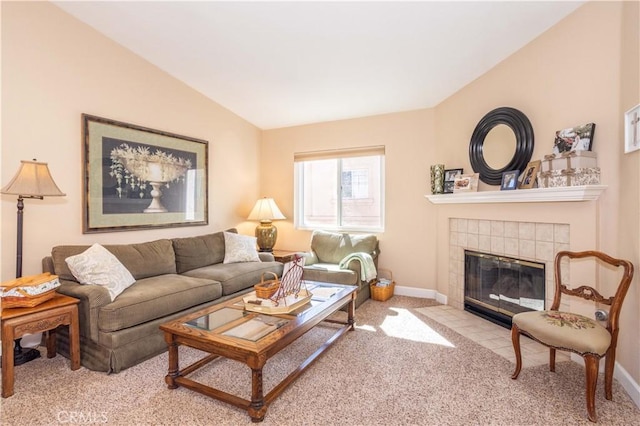 carpeted living room with lofted ceiling, a tile fireplace, and baseboards