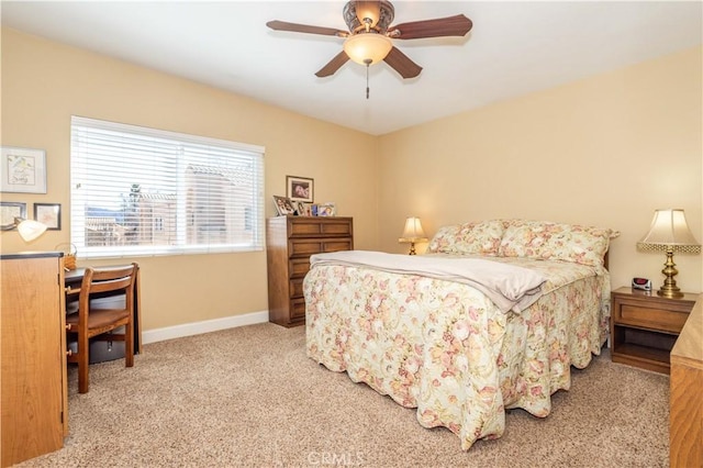 carpeted bedroom with a ceiling fan and baseboards