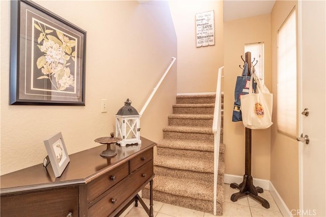 stairs featuring baseboards and tile patterned floors