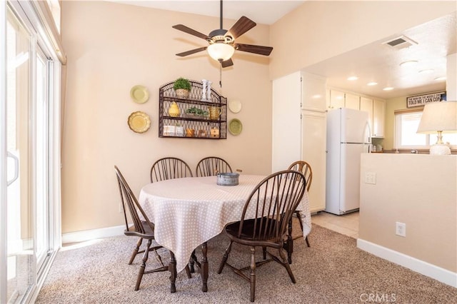 25214 Steinbeck Ave Unit G, Stevenson Ranch, CA 91381 - dining space featuring baseboards, visible vents, light carpet, and a ceiling fan