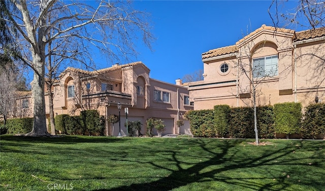 25214 Steinbeck Ave Unit G, Stevenson Ranch, CA 91381 - view of building exterior with an attached garage