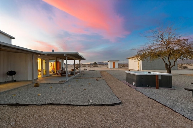 view of yard with a patio area and a hot tub