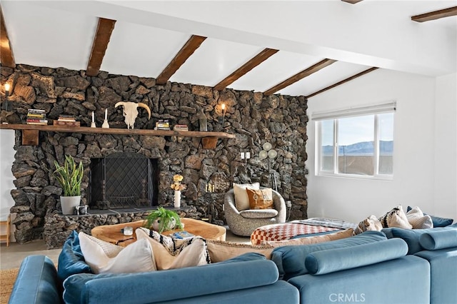 living area with a stone fireplace and lofted ceiling with beams