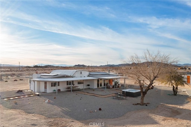 view of front of home featuring a patio area and a mountain view