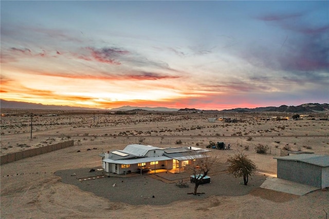 view of yard featuring a desert view and a mountain view