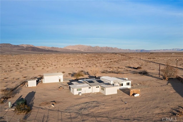 aerial view featuring a rural view, a desert view, and a mountain view